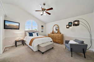 Bedroom featuring ceiling fan, lofted ceiling, and light carpet