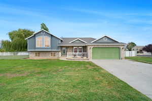 Tri-level home with a garage and a front lawn