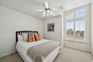 Bedroom featuring ceiling fan and light colored carpet