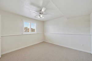 Carpeted spare room featuring ceiling fan and a textured ceiling