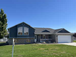 Split level home with a front yard and a garage