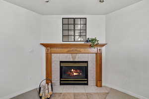 Room details featuring a tile fireplace and tile patterned floors