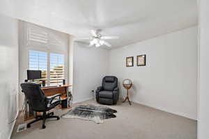 Office space featuring ceiling fan, a textured ceiling, and carpet