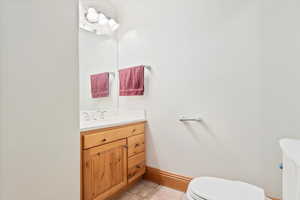 Bathroom featuring tile patterned floors, vanity, and toilet