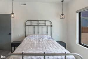 Bedroom with hardwood / wood-style flooring and multiple windows