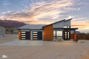 View of front facade with a mountain view and a garage