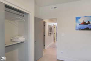 Hallway with light colored carpet