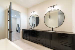 Bathroom with hardwood / wood-style floors, a tub, and vanity