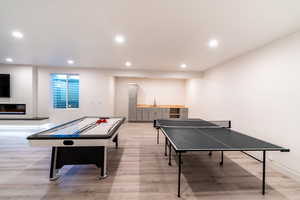 Playroom featuring sink and light hardwood / wood-style flooring