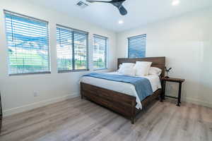 Bedroom with ceiling fan and light wood-type flooring