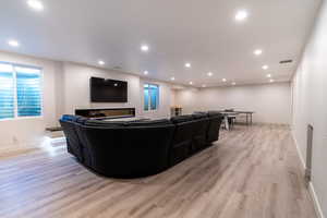 This great room is a gathering space for all types of events! Living room featuring light wood-type flooring