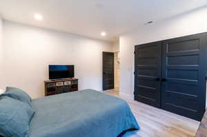 Bedroom with light hardwood / wood-style flooring