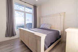 Bedroom with light hardwood / wood-style flooring