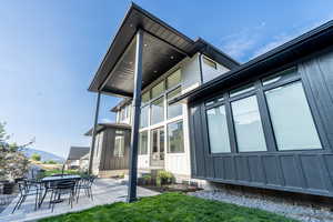 View of side of home with a mountain view and a covered patio area