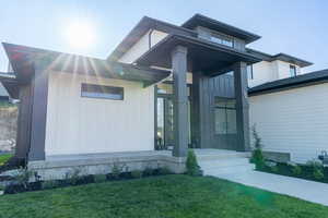 Grand entrance and walk up. View of front of property featuring a front lawn