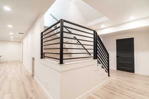 Stairway with hardwood / wood-style floors