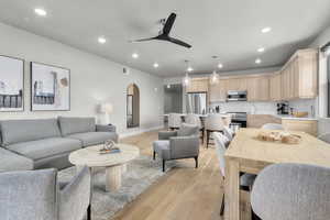 Living room featuring ceiling fan and light hardwood / wood-style floors