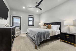 Carpeted bedroom featuring ceiling fan and access to exterior