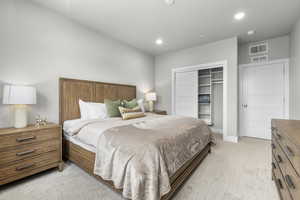 Carpeted bedroom with a closet