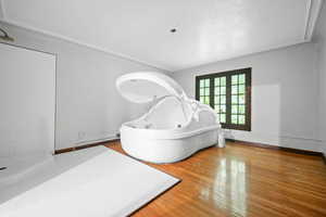 Bathroom featuring plus walk in shower, french doors, and wood-type flooring