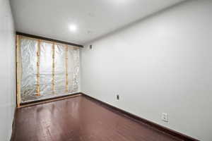 Unfurnished room with hardwood / wood-style flooring