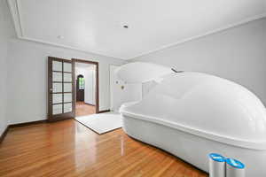 Interior space with ornamental molding and wood-type flooring