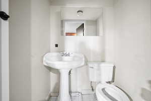 Bathroom with tile patterned floors and toilet