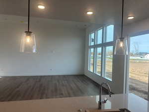 Unfurnished living room with dark wood-type flooring and a textured ceiling