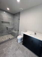 Bathroom with vanity, toilet, and walk in shower