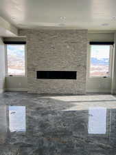 Basement living room featuring a stone fireplace