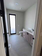 Guest bathroom with door leading to back patio. Great for entertaining