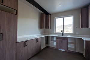 Spacious laundry room with sink and mountain view