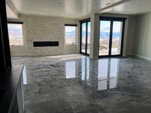 Basement living room with a stone fireplace