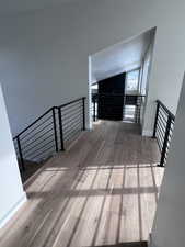 Stair landing - walnut hard flooring and vaulted ceiling