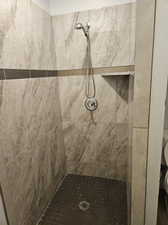 Bathroom with a tile shower and toilet