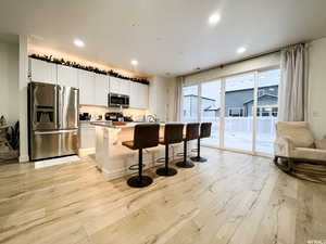 Large Kitchen with dimmable accent lighting above and below the cabinets, under the island and under the toe boards - controlled from your smart phone. Prewired for 3 pendant lights.