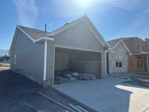 View of side of home featuring a garage