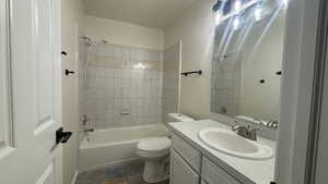 Full bathroom with vanity, toilet, and tiled shower / bath combo