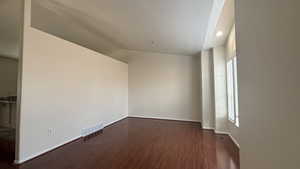 Front room with dark hardwood / wood-style flooring and lofted ceiling