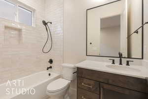 Full bathroom featuring vanity, toilet, and tiled shower / bath