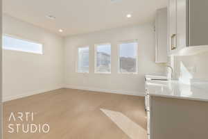 Kitchen featuring light hardwood / wood-style flooring and sink