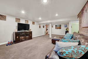 Carpeted living room with a textured ceiling