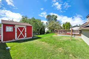 View of yard featuring a storage unit