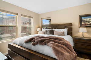 Bedroom featuring hardwood / wood-style flooring and multiple windows