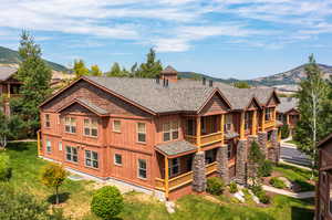 Exterior space with a front lawn and a mountain view