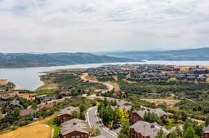 Drone / aerial view featuring a water and mountain view