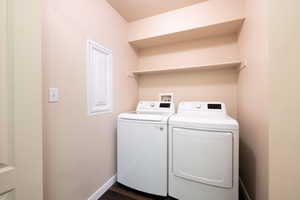 Washroom with dark wood-type flooring and separate washer and dryer