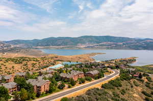 Drone / aerial view featuring a water and mountain view