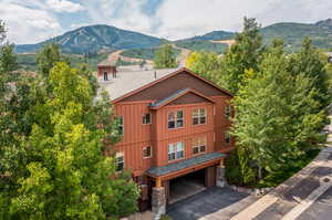 View of front of property with a garage and a mountain view