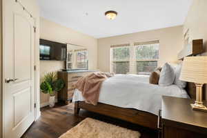 Bedroom with dark hardwood / wood-style floors